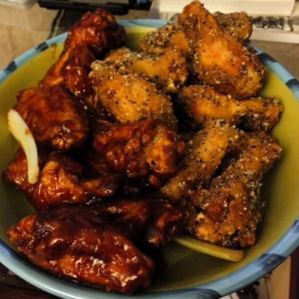 A bowl of America's Best Wings, with half sauced and half dry-rubbed wings.